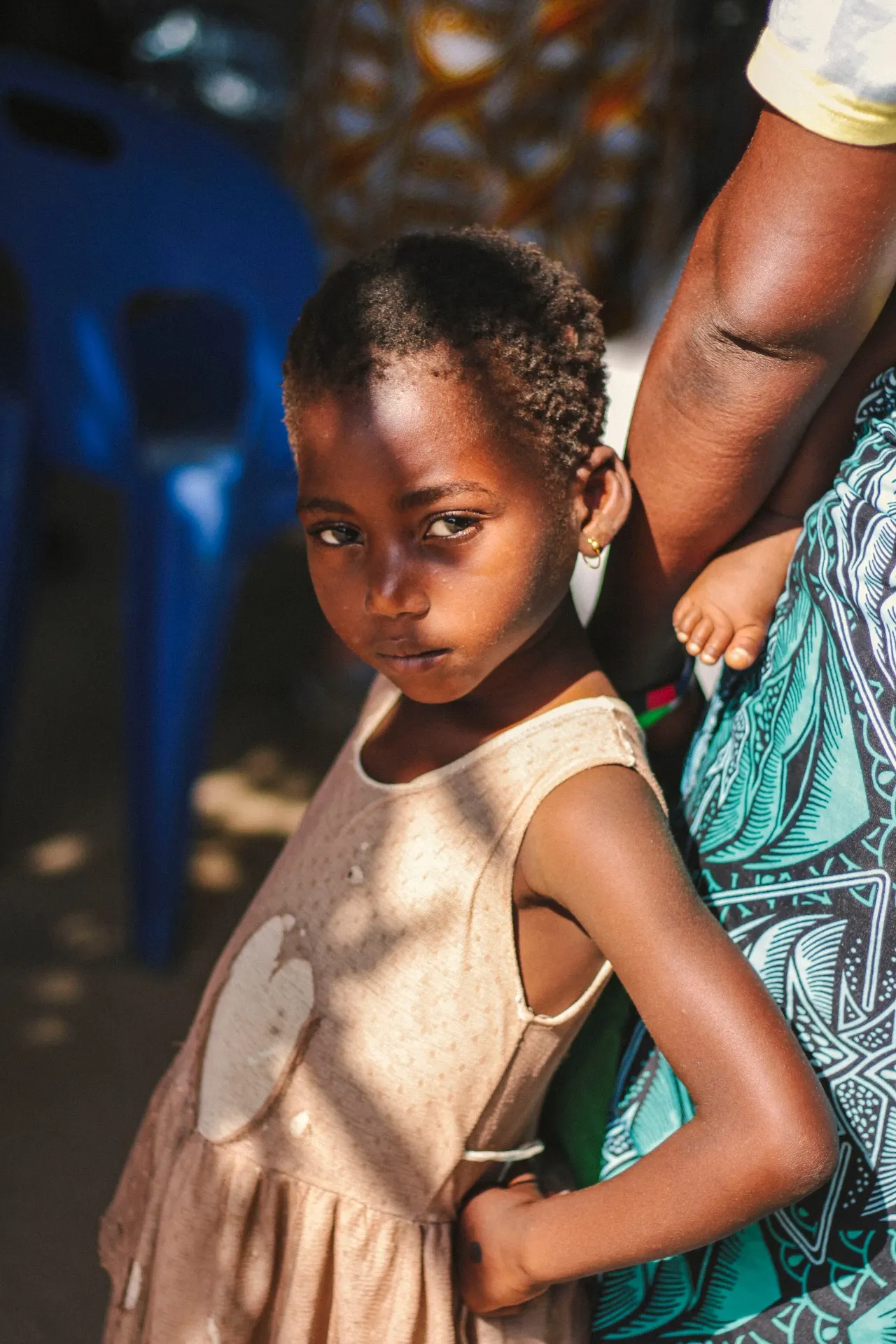 Girl standing close to her mother
