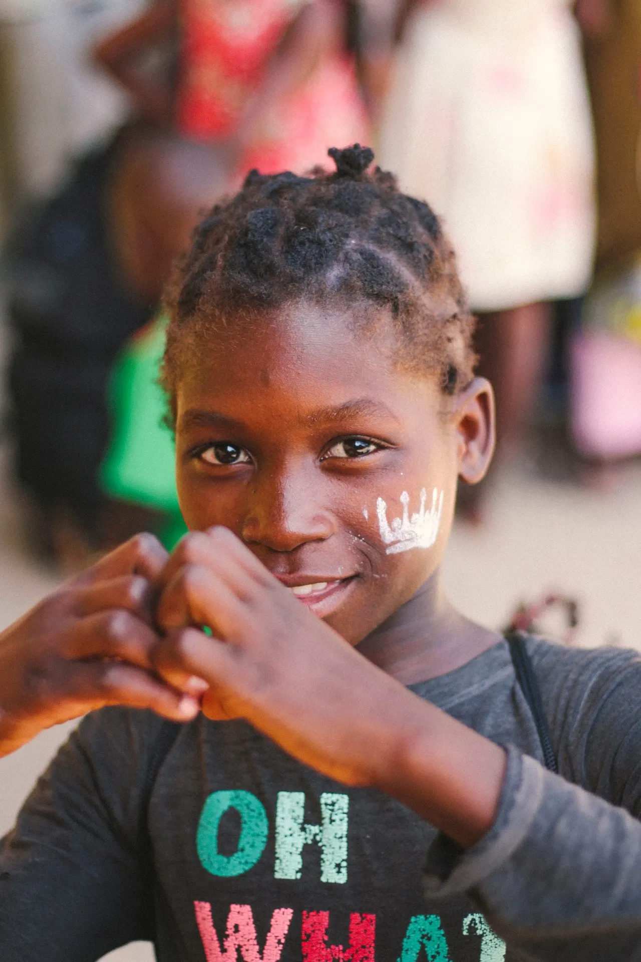Girl with white face paint and a smile